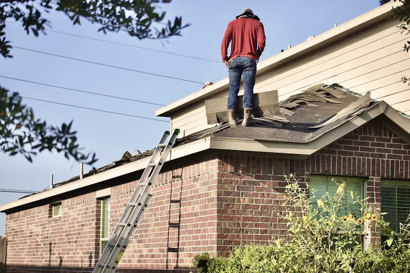 Professional roofer working on a residential roof in Northwood Edens